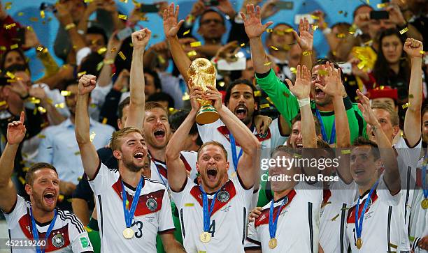 Benedikt Hoewedes of Germany celebrates with the World Cup trophy after defeating Argentina 1-0 in extra time during the 2014 FIFA World Cup Brazil...