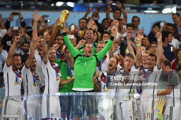Manuel Neuer of Germany lifts the World Cup trophy with his team after defeating Argentina 1-0 in extra time during the 2014 FIFA World Cup Brazil...