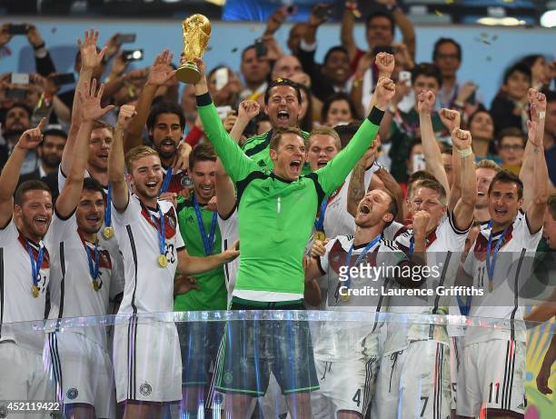 Manuel Neuer of Germany lifts the World Cup trophy with his team after defeating Argentina 1-0 in extra time during the 2014 FIFA World Cup Brazil...