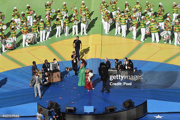 Singer Shakira holds her son Milan Pique as she performs with Alexandre Pires, Ivete Sangalo and Carlinhos Brown during the 2014 FIFA World Cup...