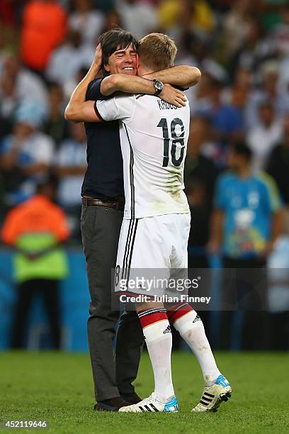 Head coach Joachim Loew and Toni Kroos of Germany celebrate after defeating Argentina 1-0 in extra time during the 2014 FIFA World Cup Brazil Final...