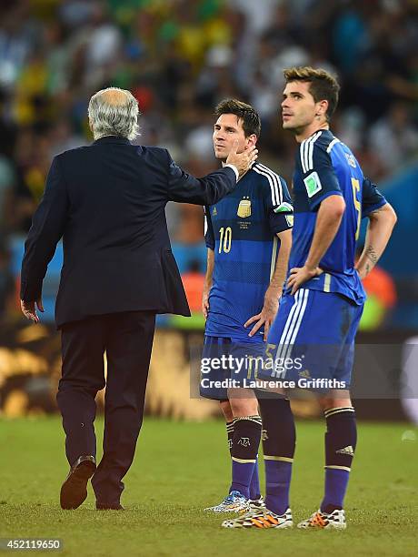 Head coach Alejandro Sabella of Argentina consoles Lionel Messi after being defeated by Germany 1-0 in extra time during the 2014 FIFA World Cup...