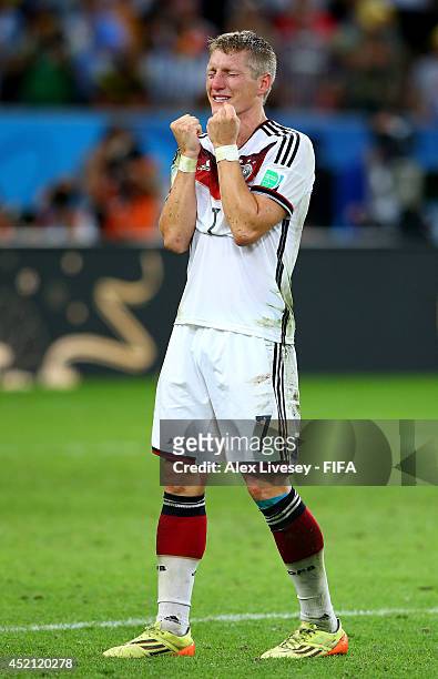 Bastian Schweinsteiger of Germany celebrates the 1-0 win in the 2014 FIFA World Cup Brazil Final match between Germany and Argentina at Maracana on...