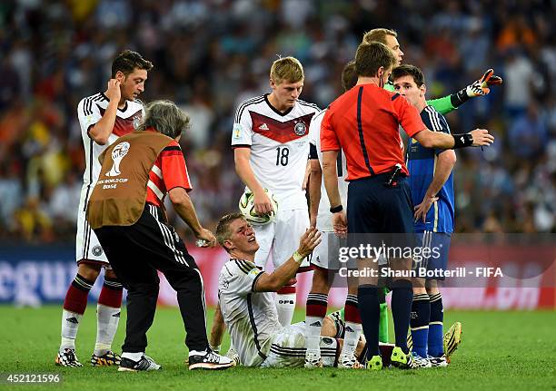 Bastian Schweinsteiger of Germany appeals to referee Nicola Rizzoli as he bleeds after a clash during the 2014 FIFA World Cup Brazil Final match...