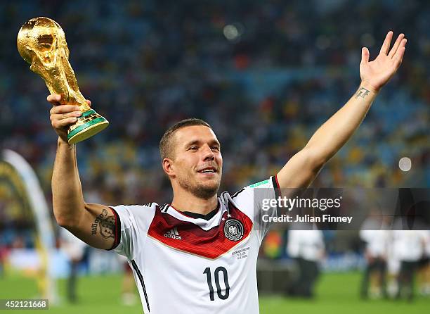 Lukas Podolski of Germany celebrates with the World Cup trophy after defeating Argentina 1-0 in extra time during the 2014 FIFA World Cup Brazil...