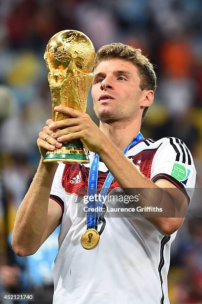 Thomas Mueller of Germany celebrates with the World Cup trophy after defeating Argentina 1-0 in extra time during the 2014 FIFA World Cup Brazil...