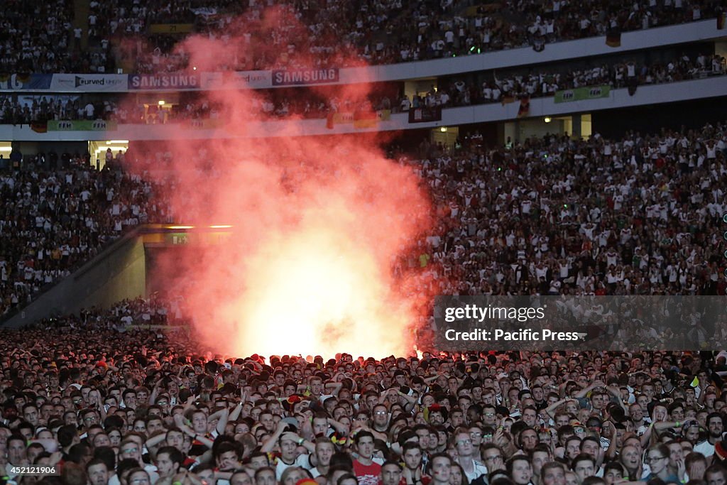 German fans burn a bengal fire during the public viewing. 50...