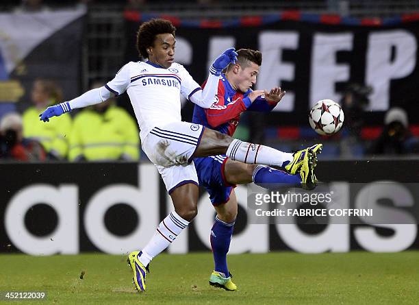 Chelsea's Brazilian midfielder Willian vies for the ball with Basel's Swiss midfielder Taulant Xhaka during the UEFA Champions League group E...