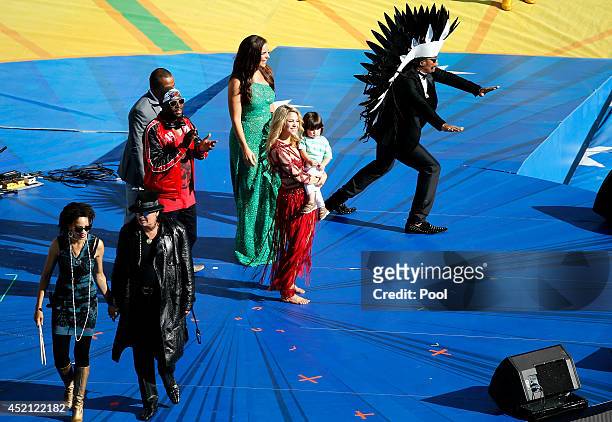 Musicians Carlos Santana, Wyclef Jean, Alexandre Pires, Ivete Sangalo, Shakira and her son Milan Pique and Carlinhos Brown on stage during the...