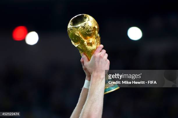 Andre Schuerrle of Germany holds up the World Cup trophy after the 2014 FIFA World Cup Brazil Final match between Germany and Argentina at Maracana...