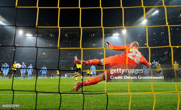 Marco Reus of Dortmund scores from the penalty spot past goalkeeper Pepe Reina of Napoli during the UEFA Champions League Group F match between...