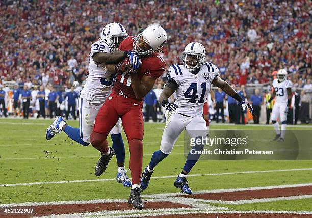 Wide receiver Larry Fitzgerald of the Arizona Cardinals catches a touchdown reception past cornerback Cassius Vaughn strong safety Antoine Bethea of...