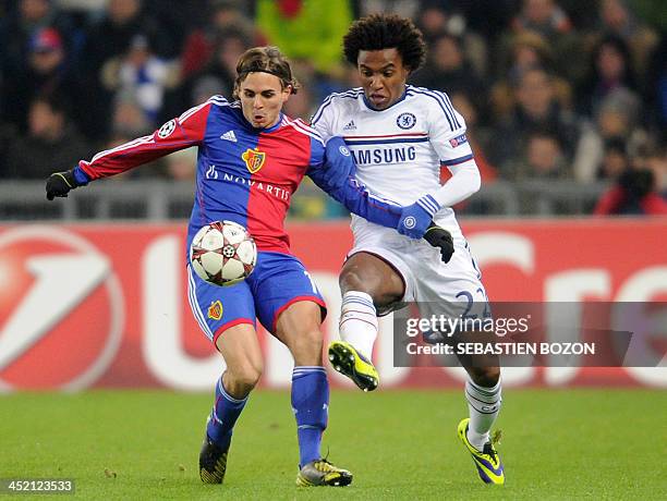 Basel's Swiss defender Kay Voser vies for the ball with Chelsea's Brazilian midfielder Willian during the UEFA Champions League group E football...