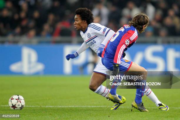 Chelsea's Brazilian midfielder Willian vies for the ball with Basel's Swiss defender Kay Voser during the UEFA Champions League group E football...