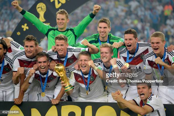 Bastian Schweinsteiger celebrates with the trophy together with team mates after the 2014 FIFA World Cup Brazil Final match between Germany and...