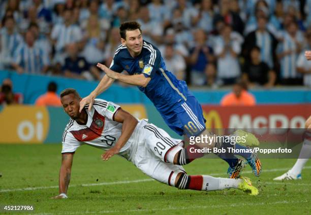 Jerome Boateng of Germany tackles Lionel Messi of Argentina during the 2014 FIFA World Cup Brazil Final match between Germany and Argentina at the...
