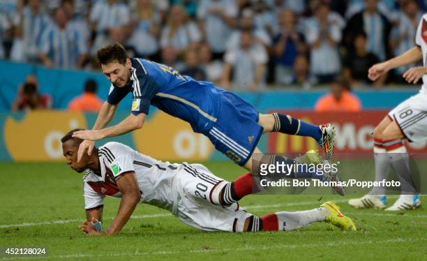 Jerome Boateng of Germany tackles Lionel Messi of Argentina during the 2014 FIFA World Cup Brazil Final match between Germany and Argentina at the...