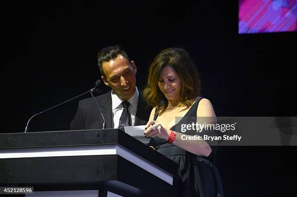 Rusk Artistic Director Gerard Caruso and Conair Corporation VP Marketing & Education Gloria Luna present the Hair Color Award during The North...