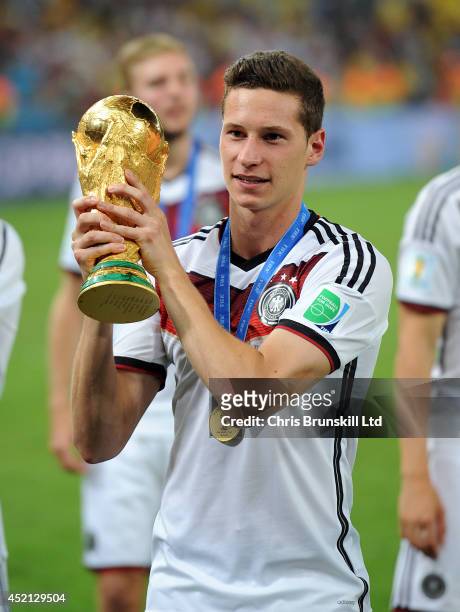 Julian Draxler of Germany lifts the trophy following the 2014 World Cup Final match between Germany and Argentina at Maracana Stadium on July 13,...
