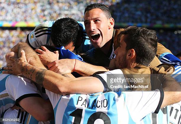 Maxi Rodriguez of Argentina celebrates Angel Di Maria of Argentina goal during the 2014 FIFA World Cup Brazil Round of 16 match between Argentina and...