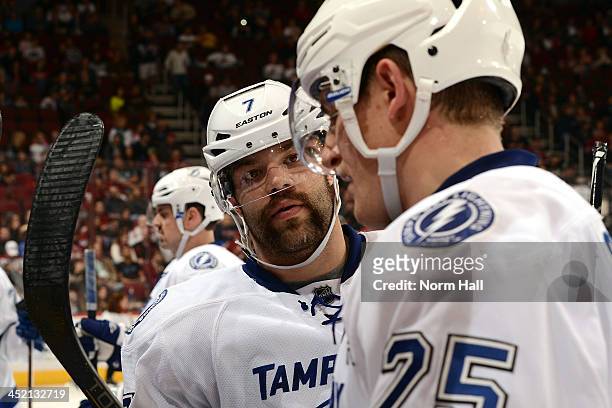 Radko Gudas of the Tampa Bay Lightning listens to teammate Matthew Carle during a stop in play against the Phoenix Coyotes at Jobing.com Arena on...