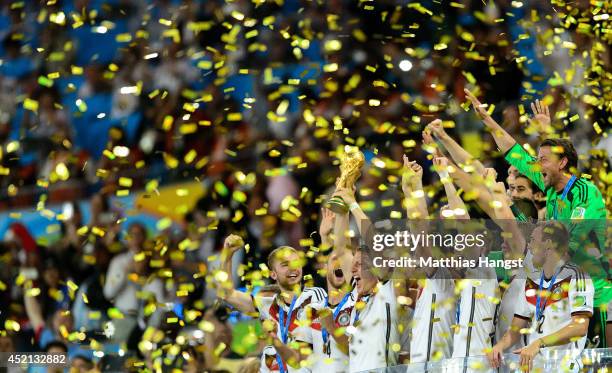 Germany celebrate with the World Cup trophy after defeating Argentina 1-0 in extra time during the 2014 FIFA World Cup Brazil Final match between...