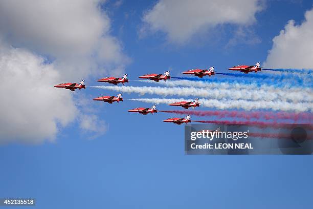 The Red Arrows perform a flypast to formally open the Farnborough air show in Hampshire, England, on July 14, 2014. The biennial event sees leading...