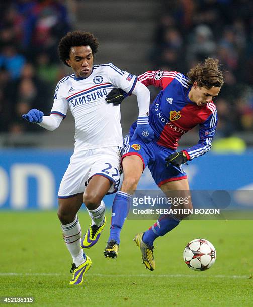Chelsea's Brazilian midfielder Willian vies for the ball with Basel's Swiss defender Kay Voser during the UEFA Champions League group E football...