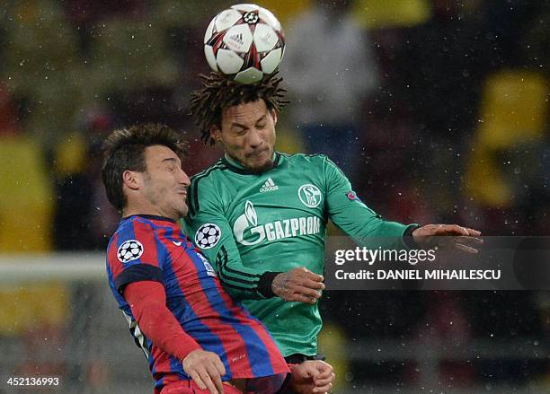 Bucharest's midfielder Gabriel Iancu and Schalke's US midfielder Jermaine Jones vie for the ball during the UEFA Champions League Group E football...