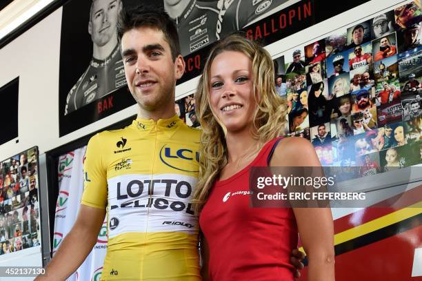 France's Tony Gallopin wearing the overall leader's yellow jersey poses with his girlfriend French cyclist Marion Rousse at the departure village in...