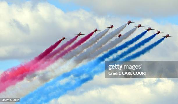 The Red Arrows perform a flypast to formally open the Farnborough air show in Hampshire, England, on July 14, 2014. The biennial event sees leading...