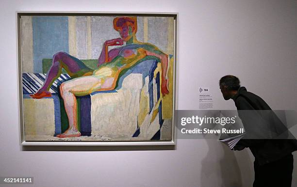 At the preview viewing a man looks at Frantisek Kupka's "Planes by Colours, Large Nude". The AGO hosts "The Great Upheaval," a collection of art from...