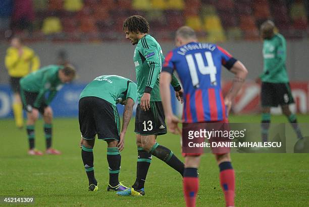 Schalke's US midfielder Jermaine Jones and other players react at the end of the UEFA Champions League Group E football match FC Steaua Bucharest vs...