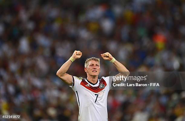 Bastian Schweinsteiger of Germany celebrates victory after the 2014 FIFA World Cup Brazil Final match between Germany and Argentina at Maracana on...