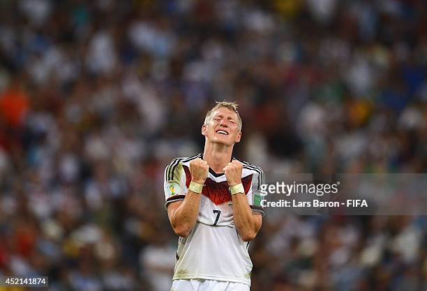 Bastian Schweinsteiger of Germany celebrates victory after the 2014 FIFA World Cup Brazil Final match between Germany and Argentina at Maracana on...