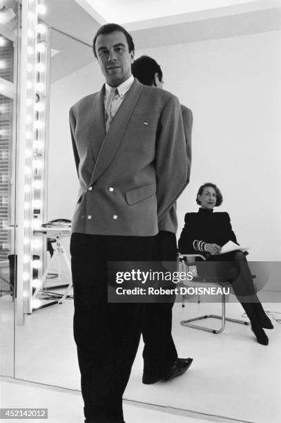 Thierry Mugler posing against a mirror in front of Andree Putman sitting in an armchair, 1985 in France.