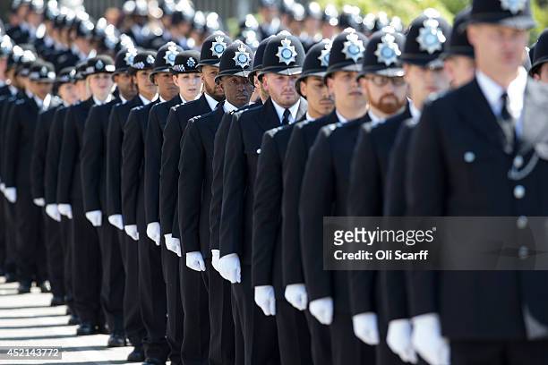 Police cadets who have completed their training take part in their 'Passing Out Parade' in the grounds of West Ham United Football Club on July 14,...