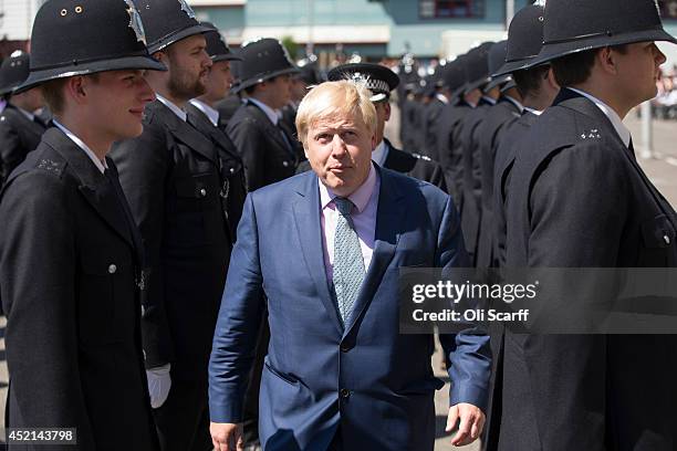 Boris Johnson, the Mayor of London, inspects police cadets who have completed their training during their 'Passing Out Parade' in the grounds of West...