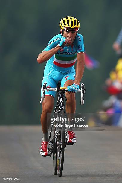Vincenzo Nibali of Italy and the Astana Pro Team bites his thumb in honour of his recently born daughter as he celebrates crossing the finish line to...