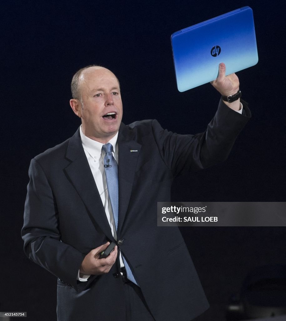 Microsoft Chief Operating Officer Kevin Turner holds up a HP Stream
