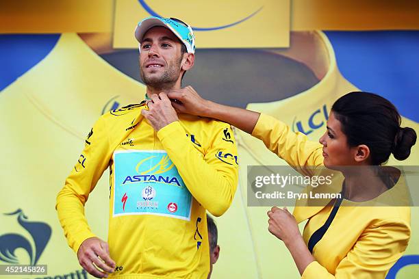 Vincenzo Nibali of Italy and the Astana Pro Team celebrates on the podium as he regains the overall race leader's yellow jersey after the tenth stage...