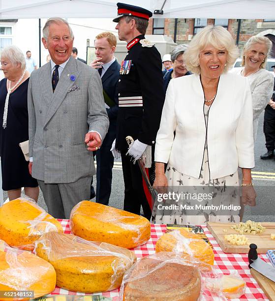 Prince Charles, Prince of Wales and Camilla, Duchess of Cornwall sample some cheese as they tour a market on day one of their annual visit to Devon...