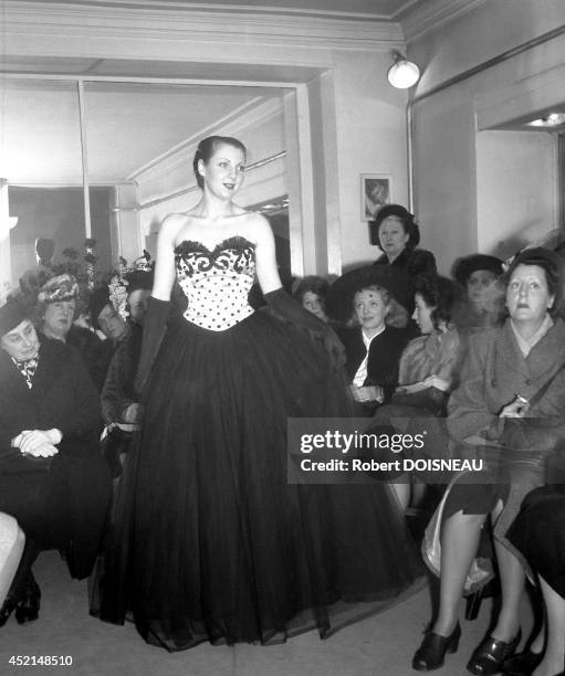 Model walking the runway during a Dior winter fashion show, 1947 in Paris, France.