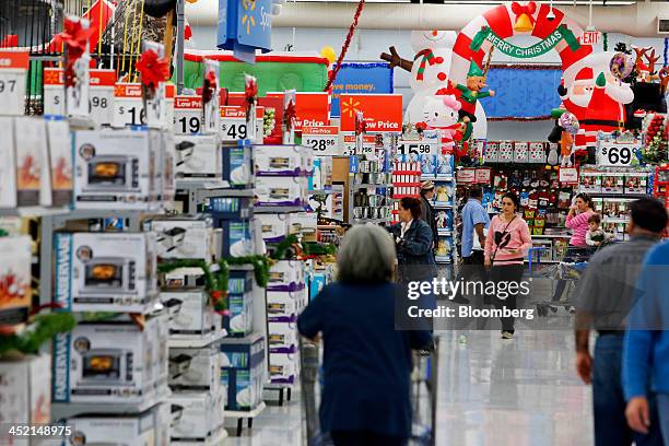 Customers shop at a Wal-Mart Stores Inc. Location ahead of Black Friday in Los Angeles, California, U.S., on Tuesday, Nov. 26, 2013. Wal-Mart Stores...