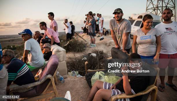 Israelis look for outgoing rocket fire from Gaza and wait for Israeli airstrikes from a hill overlooking the Gaza Strip on July 14, 2014 in Sderot,...