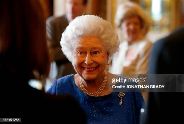 Britain's Queen Elizabeth II greets guests at a reception at Buckingham Palace for winners of The Queen's Awards for Enterprise 2014 in London on...