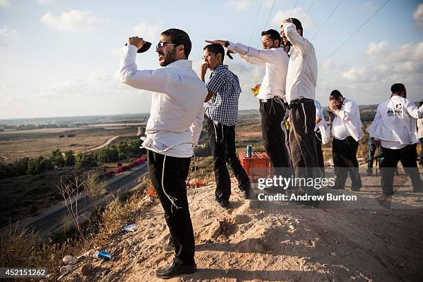 Israelis look for outgoing rocket fire from Gaza and wait for Israeli airstrikes from a hill overlooking the Gaza Strip on July 14, 2014 in Sderot,...