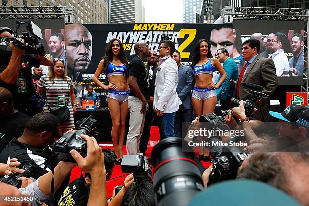 Marcos Maidana and Floyd Mayweather Jr. Face-off during a news conference at the Pedestrian Walk in Times Square on July 14, 2014 in New York City....