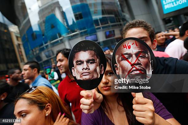 Fans look on during the Marcos Maidana and Floyd Mayweather Jr. News conference at the Pedestrian Walk in Times Square on July 14, 2014 in New York...