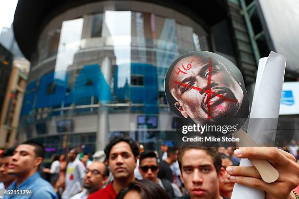 Fans look on during the Marcos Maidana and Floyd Mayweather Jr. News conference at the Pedestrian Walk in Times Square on July 14, 2014 in New York...